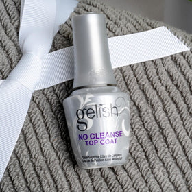 Gelish top coat curing on nail under lamp showcasing fast cure benefit