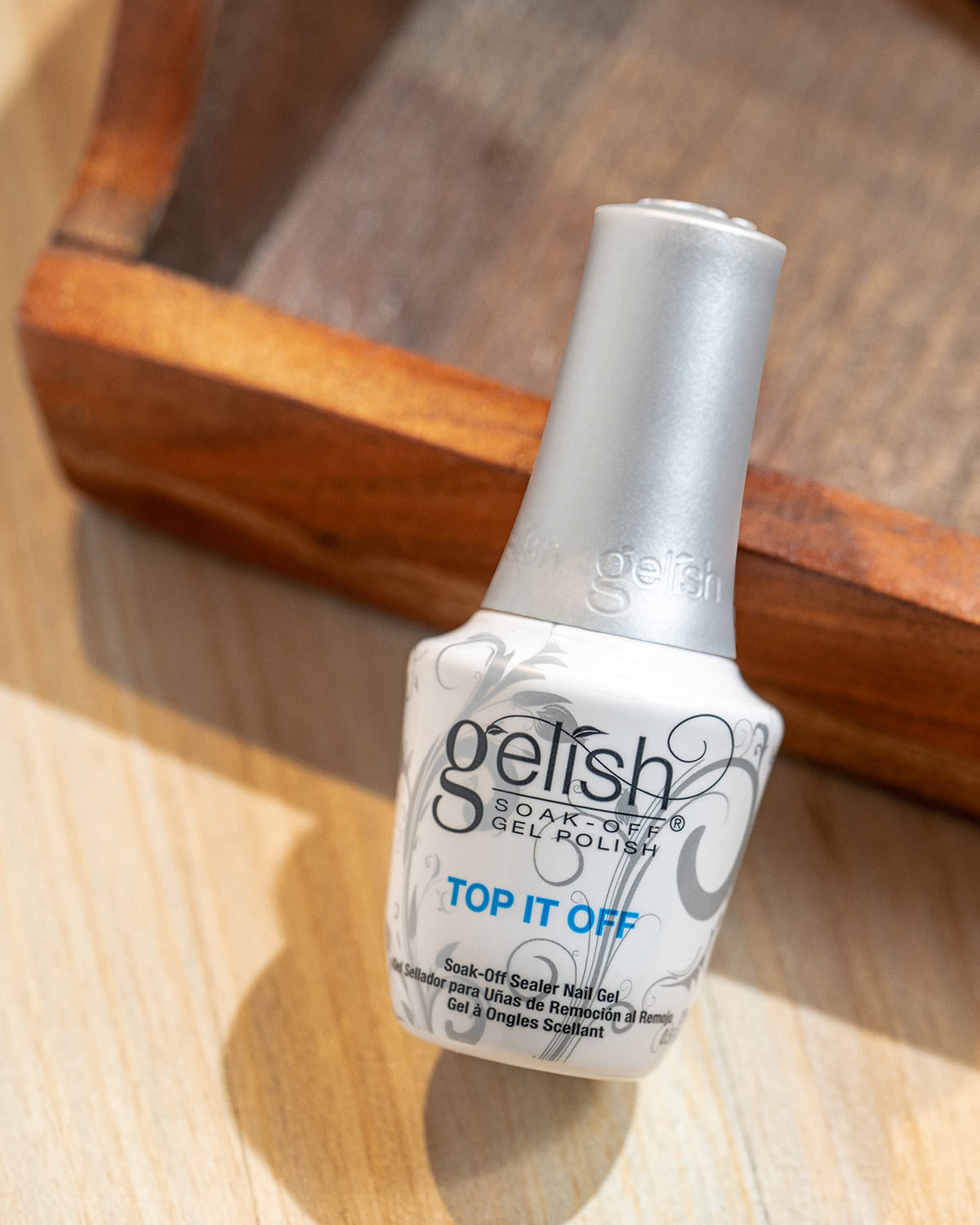 Gelish brush spreading smooth top coat texture to demonstrate even application and high shine