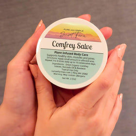 generic comfrey salve farm harvest photo with comfrey leaves and family farm setting conveying organic sourcing