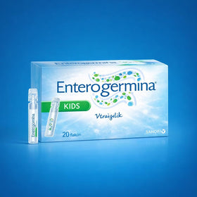 Child at breakfast with EnterogerminaKids vial nearby illustrating routine use