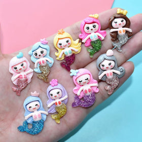 Generic toy reveal of a small mermaid figurine emerging, encouraging surprise and play