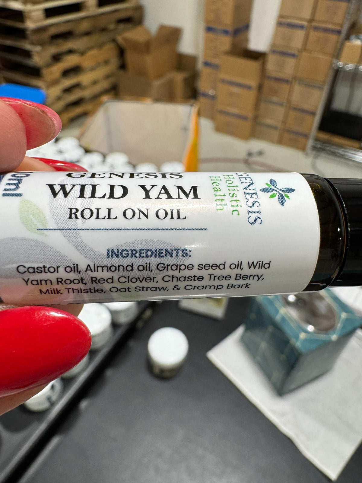 Genesis Holistic Health roll-on in a purse and hand illustrating travel-friendly daily wellness