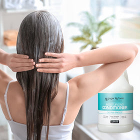 Ginger Lily Farms bottle on shower shelf suggesting a fresh ocean breeze scent
