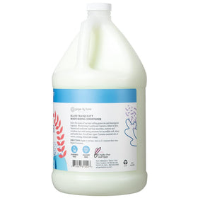 Ginger Lily Farms conditioner being poured from jug into a dispenser for easy refills