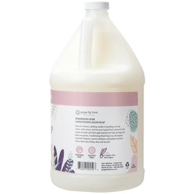 Ginger Lily Farms pouring refill into a wall dispenser demonstrating easy economical refill