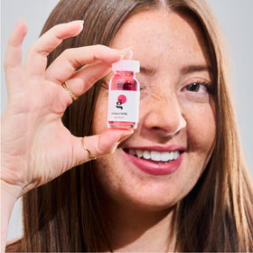 Ginger Milk ampoule next to ruler showing compact travel-friendly size