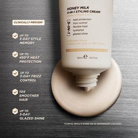 Gisou cream in hand applied to damp hair demonstrating easy distribution