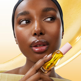 Gisou lip oil texture swatch on skin highlighting glossy finish and hydrating feel