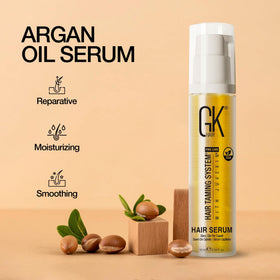 GK HAIR argan oil drop on fingertip highlighting smooth lightweight texture