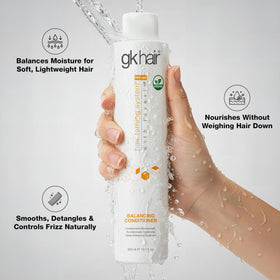 GK HAIR bottle in hand for scale and portable convenience