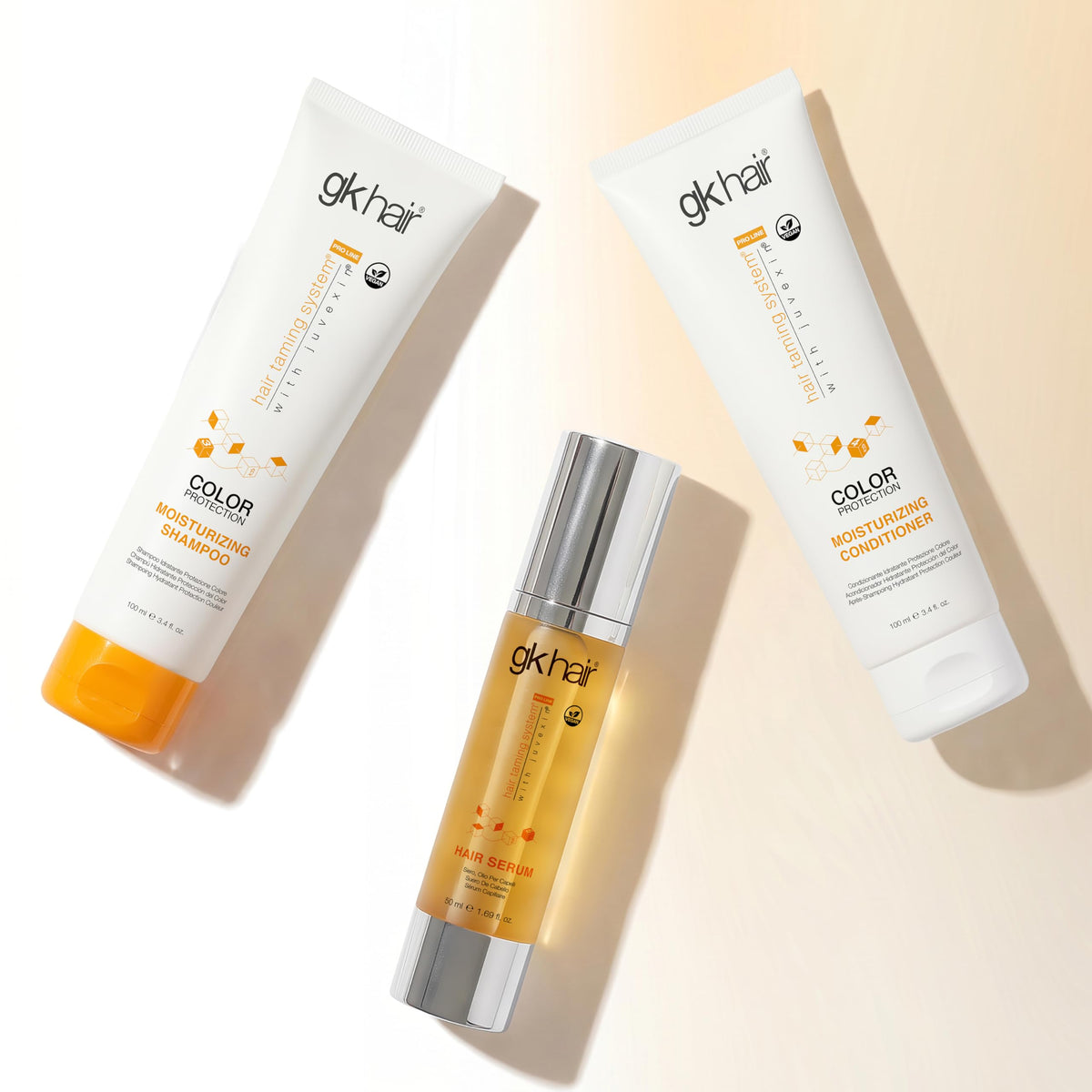 GK HAIR bottles beside a hand showing 3.4 fl oz scale for travel compliance