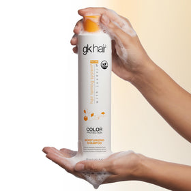 GK HAIR 10.1 fl oz bottle next to ruler showing compact travel size