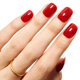 GLAMERMAID lifestyle shot pairing red nails with neutral outfit for styling ideas