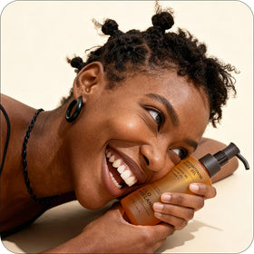 Glo Melanin applied on arm demonstrating smooth, non-greasy finish