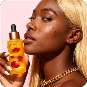Glo Melanin applied to knee and elbow reducing dry patches and adding moisture