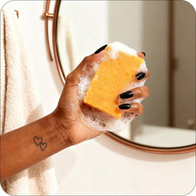 Glo Melanin soap applied to body targeting dark spots and hydration