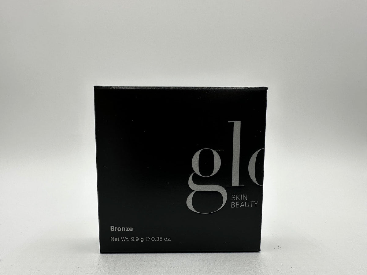 Glo Skin Beauty travel flatlay with compact beside essentials for on-the-go touchups