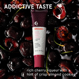 glossier Black Cherry swatch on hand showing burgundy tint and smooth hydration