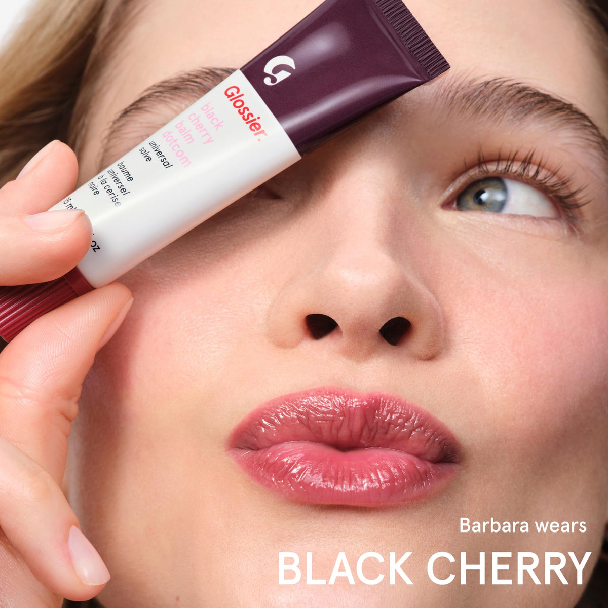 glossier Black Cherry tube in a purse travel shot showing easy on-the-go hydration