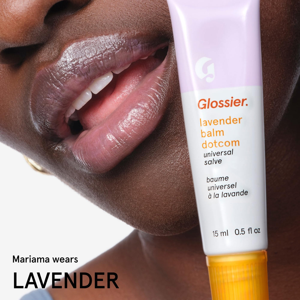 Glossier Balm Dotcom beside common items showing compact travel-friendly size
