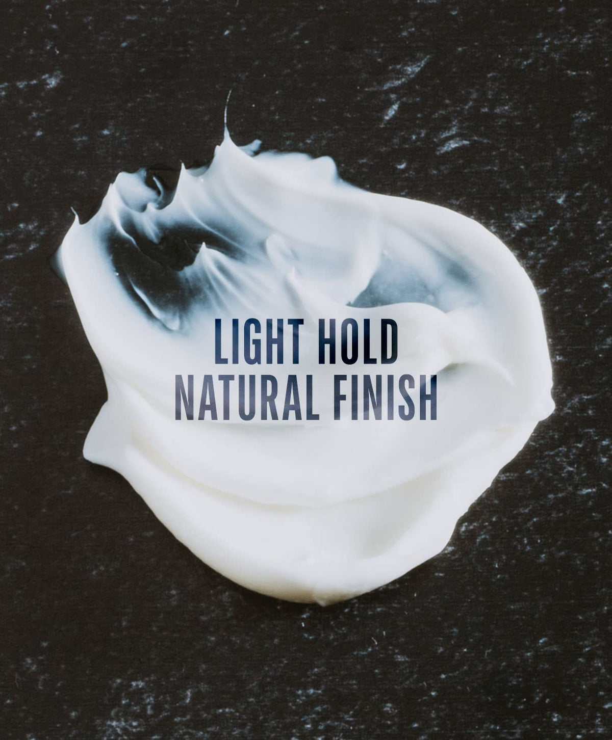 Hand applying GO247 grooming cream to damp hair for shaping and frizz control
