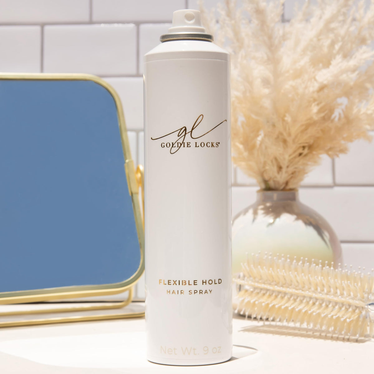 Goldie Locks bottle in hand to show real-life size and travel-friendly benefit