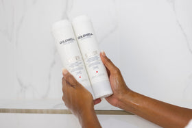 Goldwell placed on bathroom shelf in lifestyle scene suggesting daily use