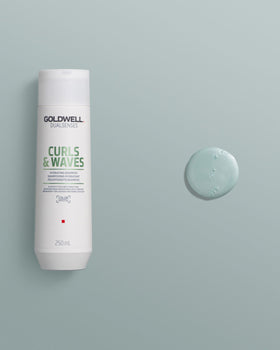Goldwell bottle on bathroom shelf demonstrating everyday curl care