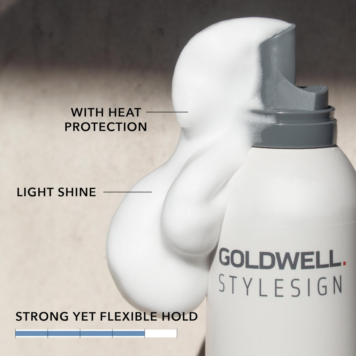 Goldwell foam on towel-dried hair for even root-to-tip distribution