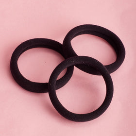 Goody elastic stretched around thick hair illustrating flexible, secure hold