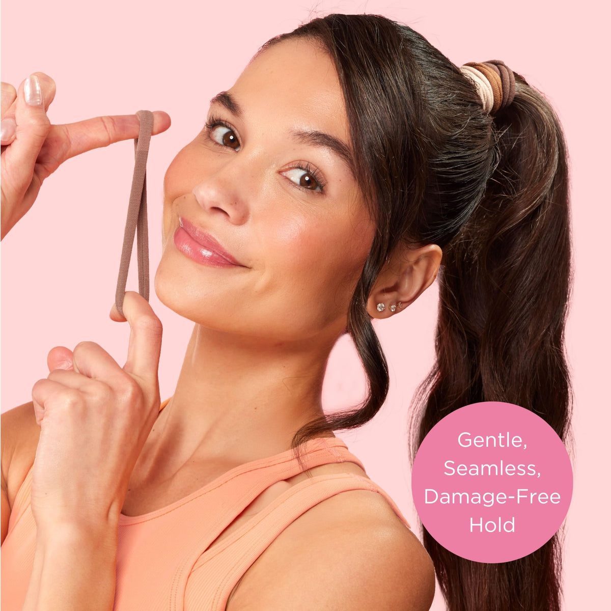 GOODY hair tie held in hand illustrating scale and easy portability