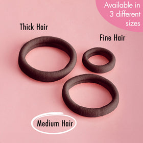 hand holding a Goody elastic to show compact size and portability