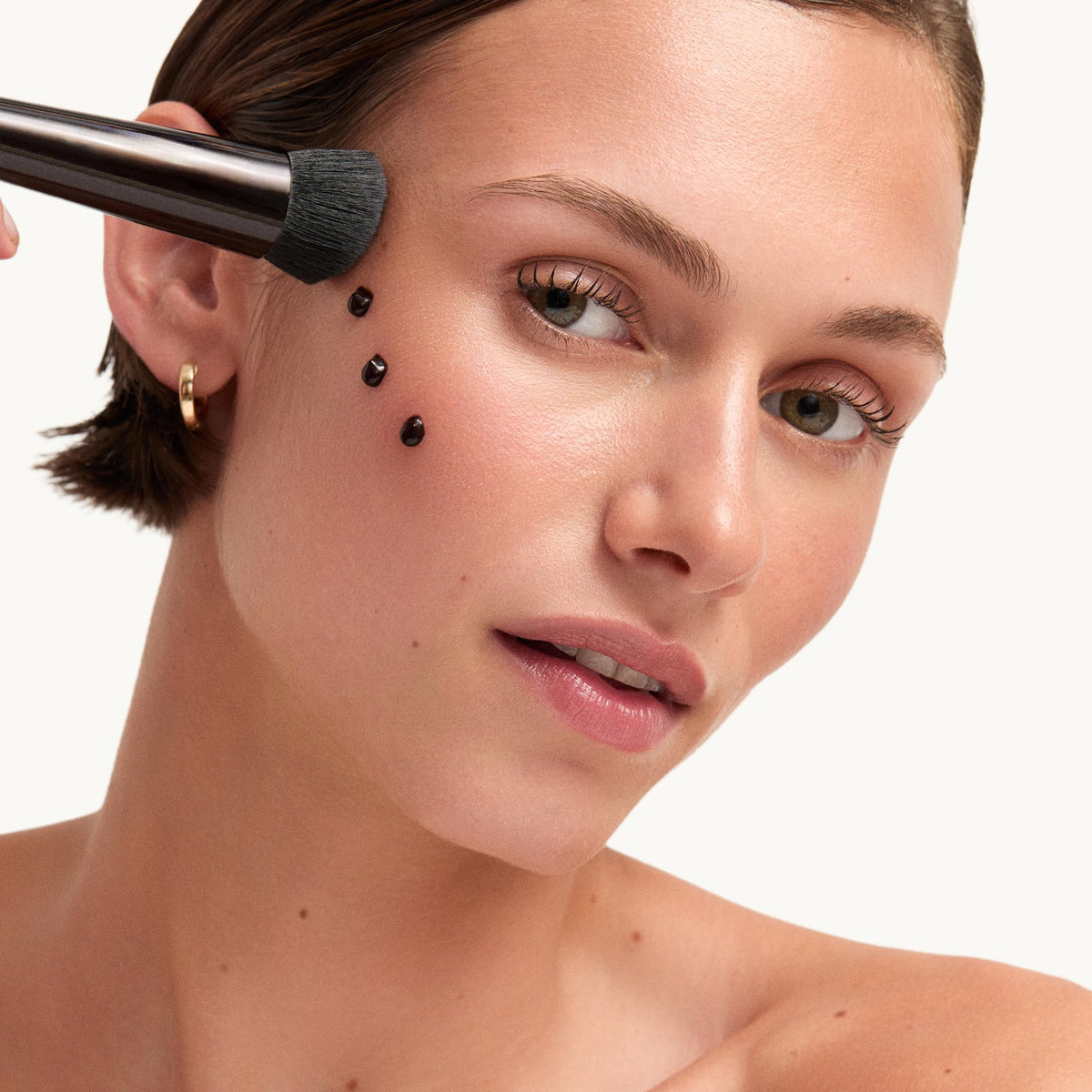 goop Summertone on brush showing buildable coverage and concentrated application