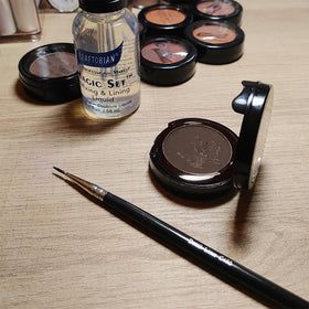 Graftobian cake liner next to brushes showing portability and toolkit compatibility