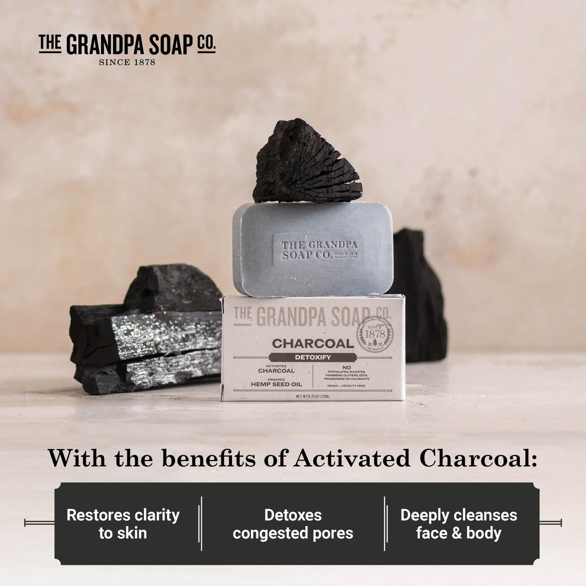 Hand holding Grandpa Soap Company charcoal bar to show actual size and scale