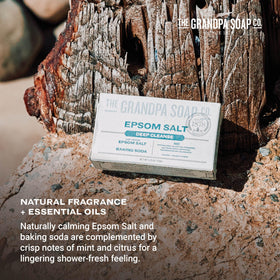 The Grandpa Soap Company bar beside a coin to show size and portable convenience