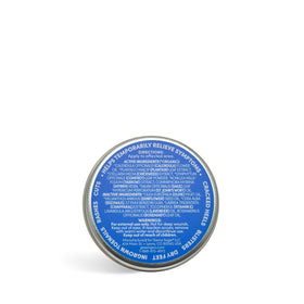 Open Green Goo tin beside ruler and label showing size, ingredients, and brand info