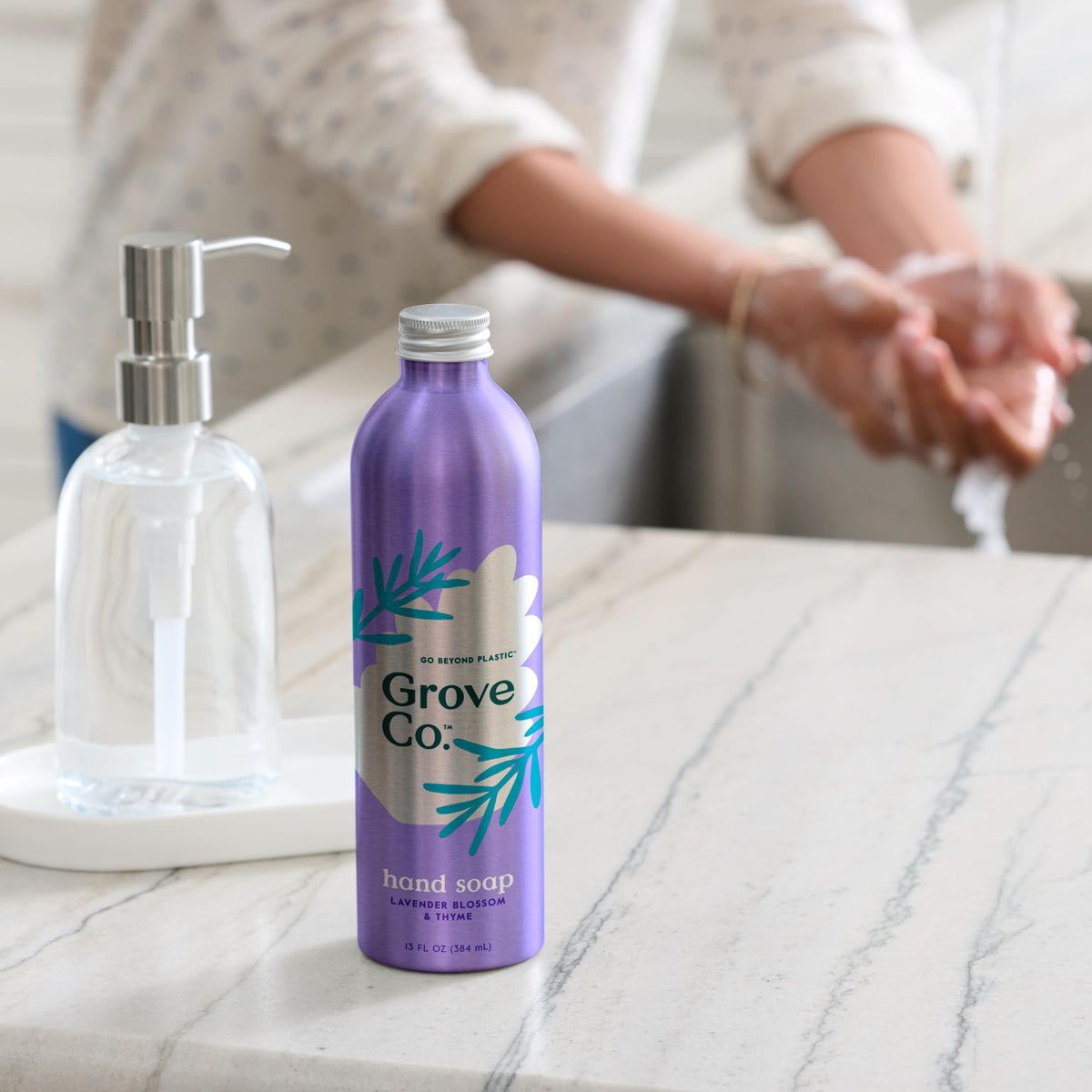 Grove Co. pouring refill into a countertop dispenser demonstrating quick top-off benefit
