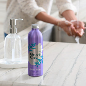 Grove Co. pouring refill into a countertop dispenser demonstrating quick top-off benefit