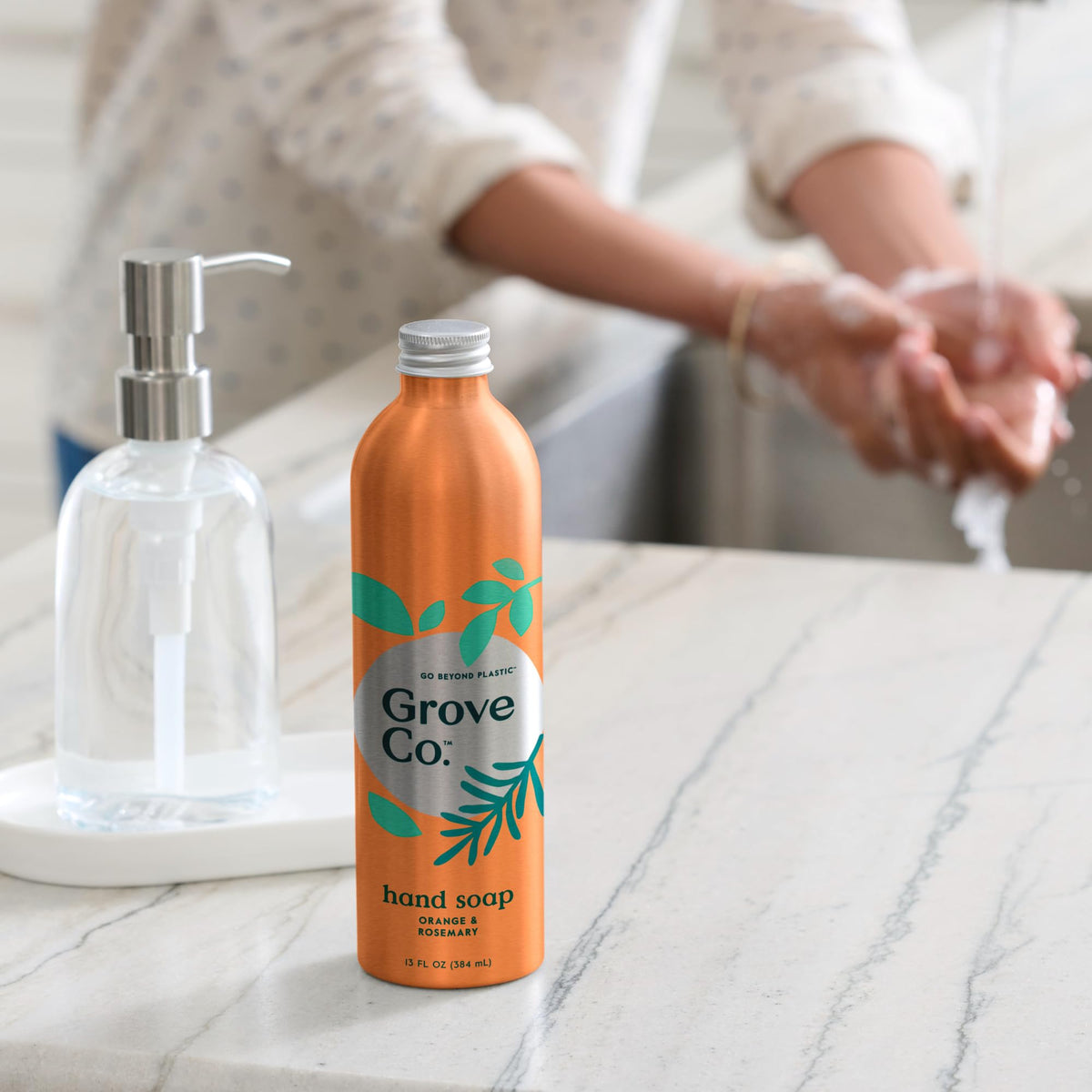 Grove Co. pouring refill into reusable dispenser demonstrating easy transfer