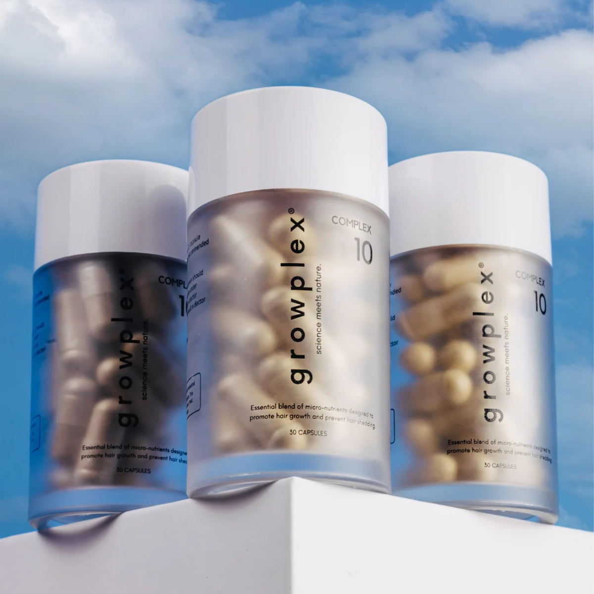 GROWPLEX scattered capsules on wood highlighting natural-inspired formula