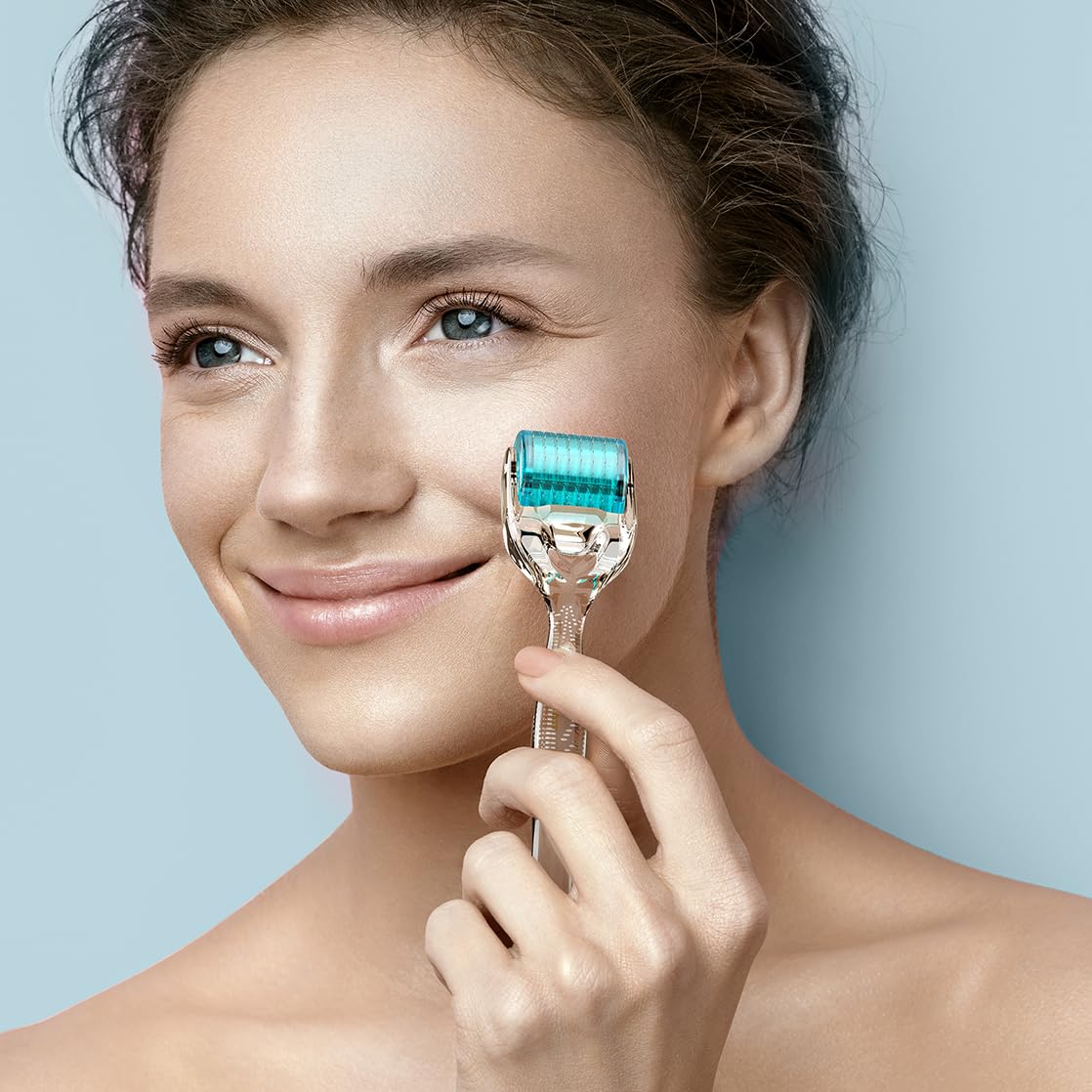 GXBRSY derma roller held in hand to show size and ergonomic grip for comfortable use
