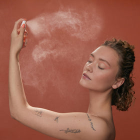 HABIT N°41 being sprayed over makeup showing touchless reapplication benefit