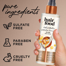 Hair Food bottle in hand showing 6.4 fl oz size and portability