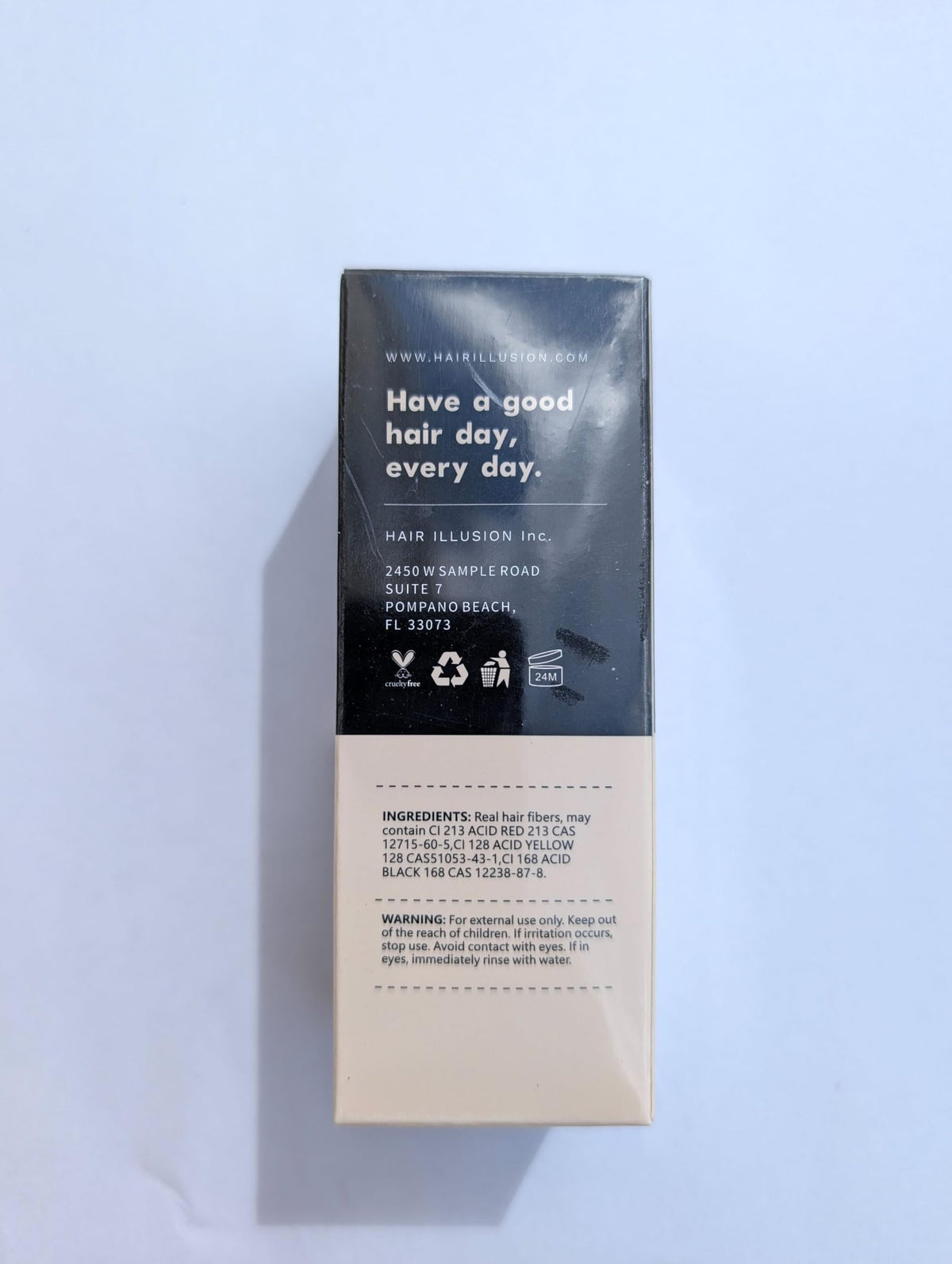 Hair Illusion jar in hand showing compact 38g size for travel convenience