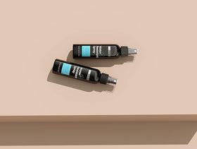 Hair Illusion bottle in hand showing pack-of-two size and scale