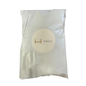 HAKOCO cleansing oil being massaged on face, demonstrating effective makeup removal