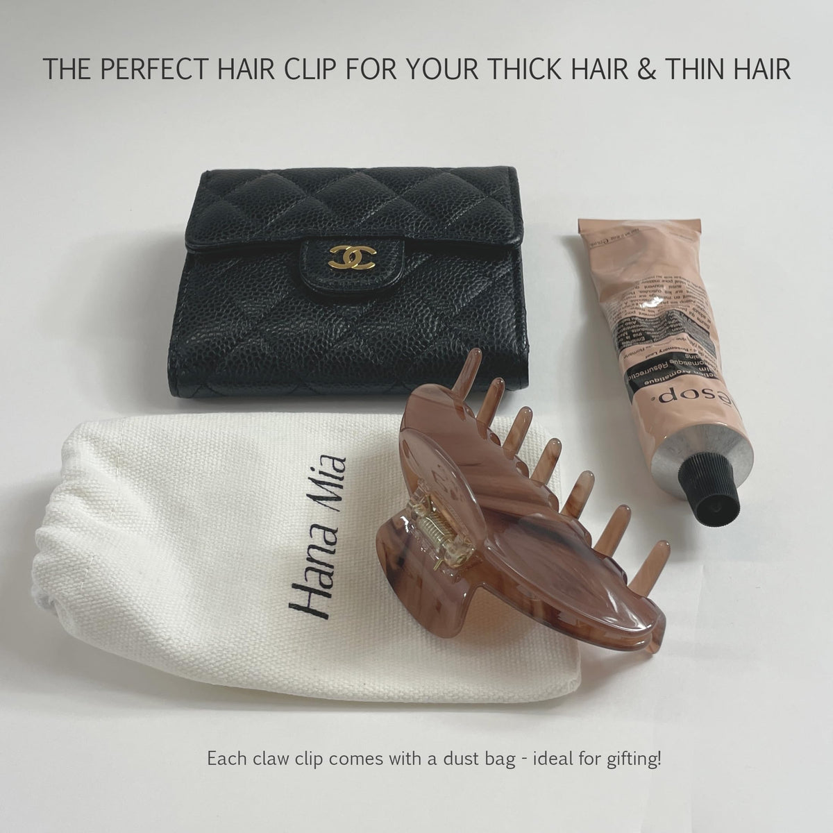 Hana Mia clip shown in hand for size scale and easy portability