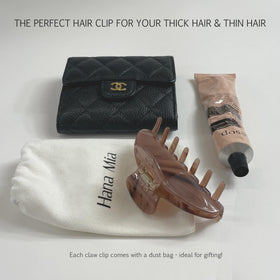 Hana Mia clip shown in hand for size scale and easy portability