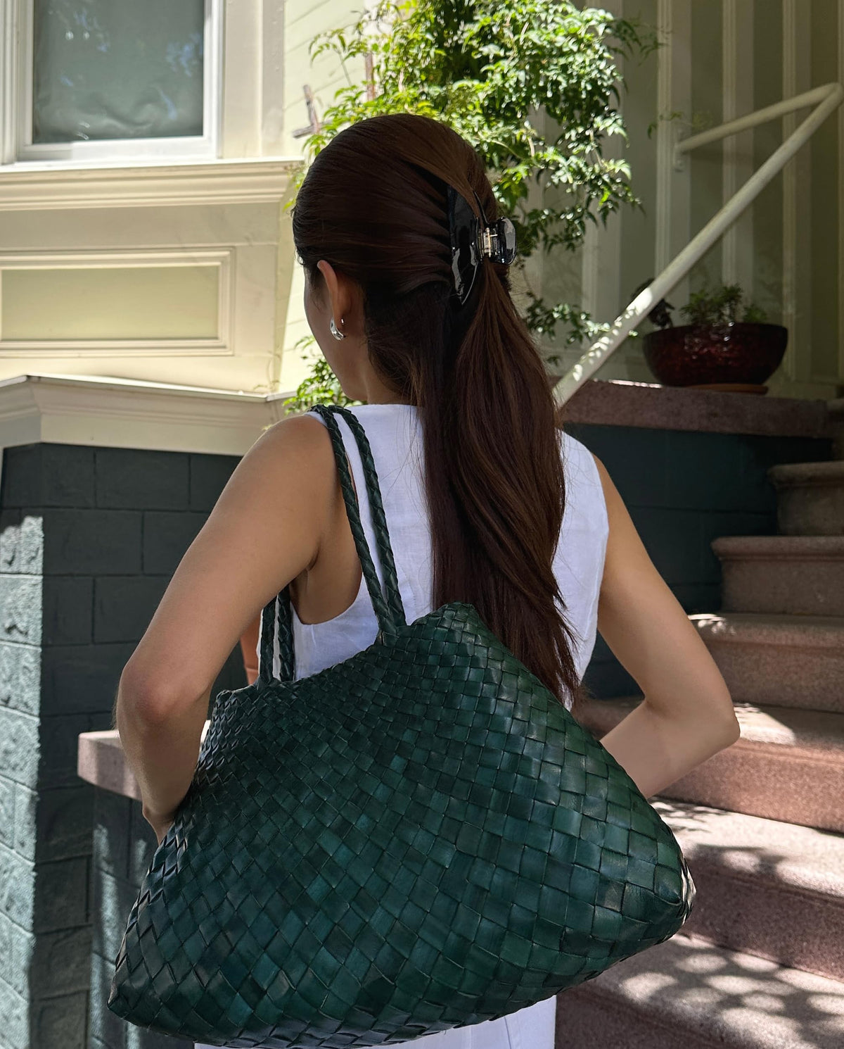 Hana Mia securing a messy bun for comfortable all-day wear